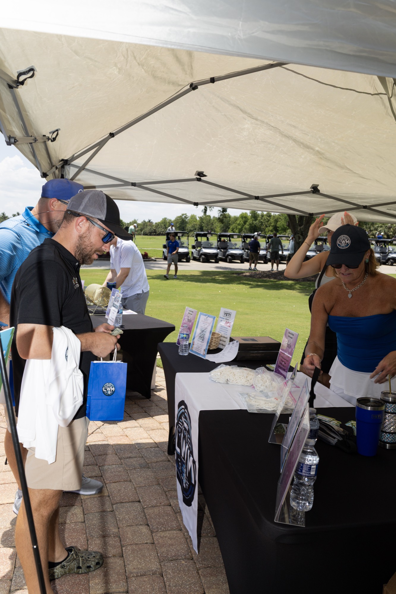Players checking in at the registration and swag tent