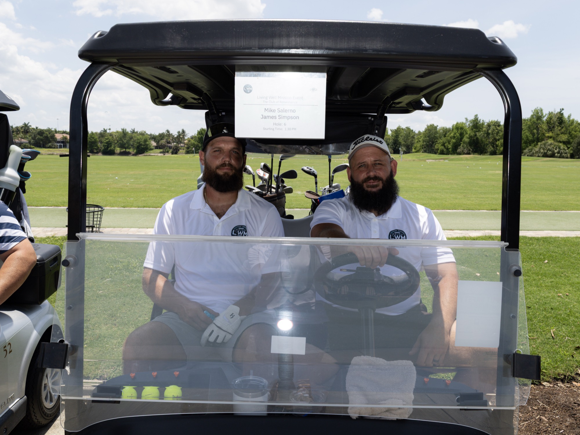 Teammates posing in their cart before the round